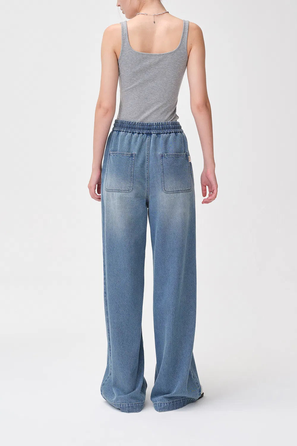 Model wearing Elastra jeans with casual street-style top
