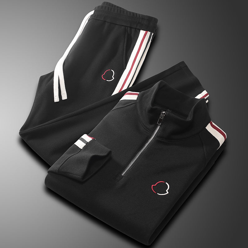 Folded tracksuit showing quarter zip top and jogger pants

