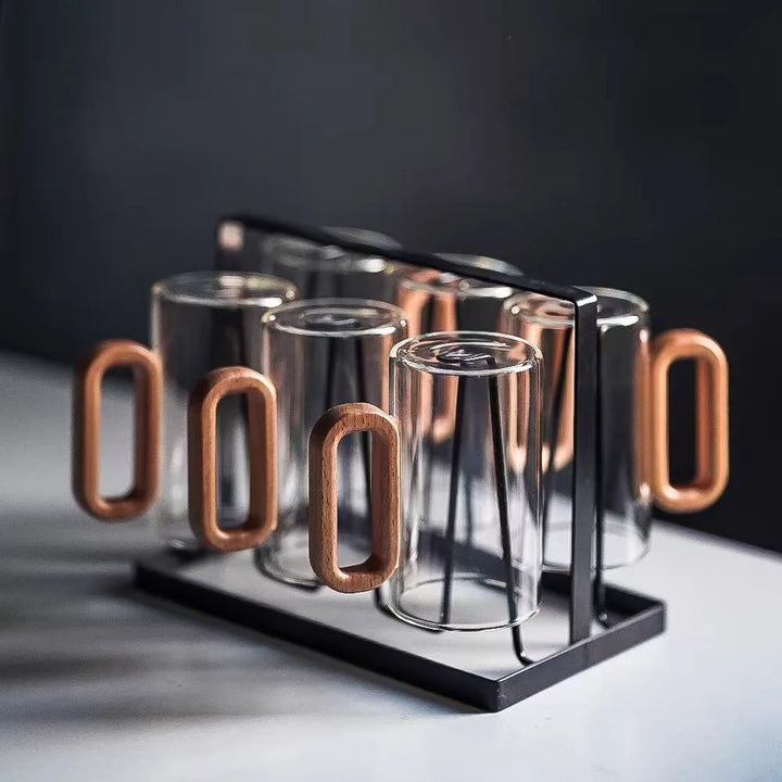 Ceramic mugs arranged on breakfast table in assorted colors

