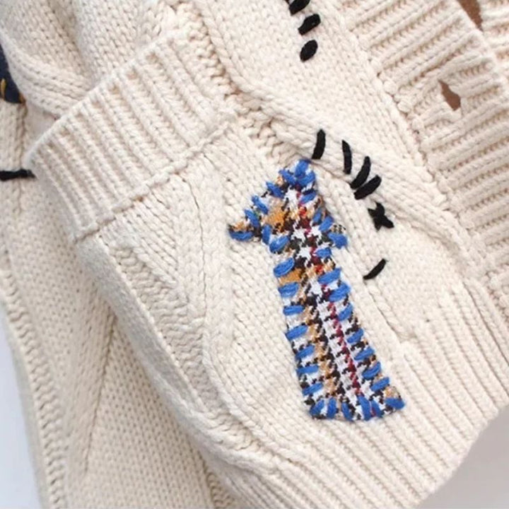 Folded knit cardigan showing lightweight texture and ribbed trim

