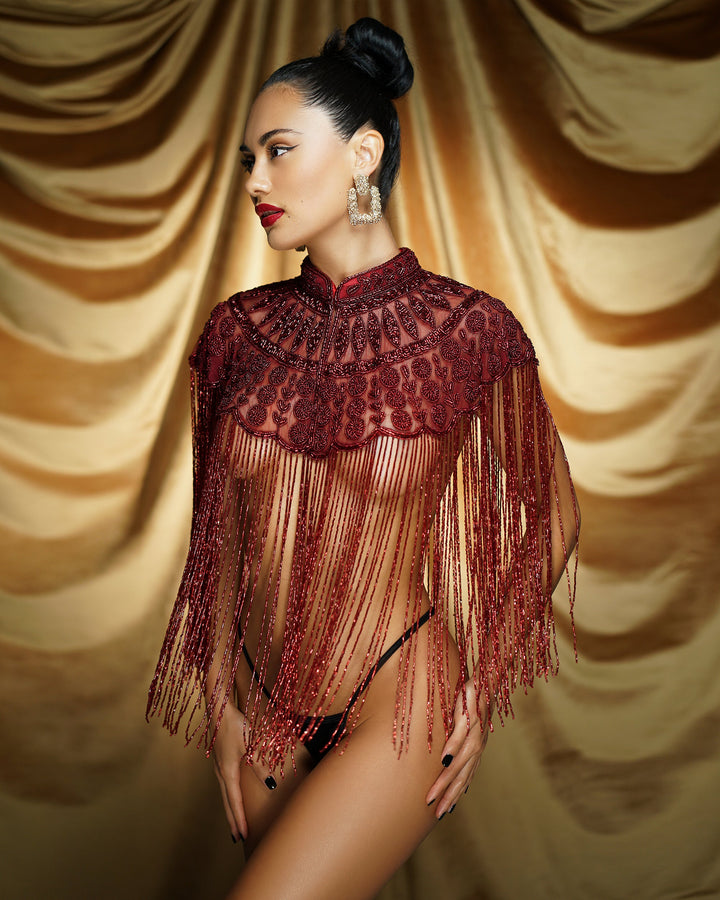 Close-up of gold beading and red jewel embroidery
